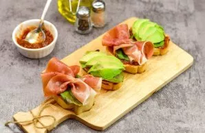 Put a little salad on top of the sauce. Put jamon on some sandwiches, avocado on others.
