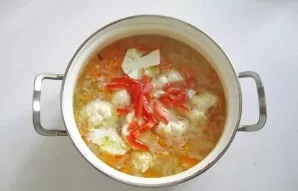 Wash the peppers, cut into strips and put in a saucepan.