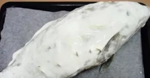 Put the fish on a baking sheet lined with paper and coat with sour cream. Next, we put it in a hot oven for 50 minutes at a temperature o...