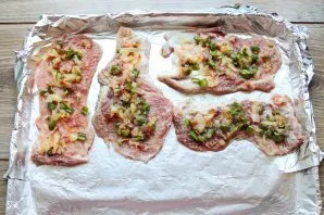 Put vegetables and bacon on top of the meat.