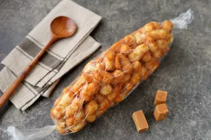 Put the slightly cooled corn on the cling film, form a sausage shape from the workpiece, wrap it in a large candy and put it in the refri...