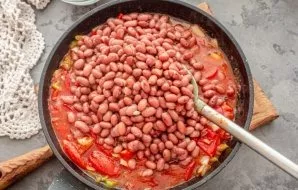Add the beans without liquid, stir, simmer everything for another couple of minutes.