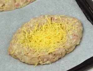 Remove the schnitzels from the oven and sprinkle with grated cheese.