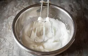 Put the egg whites in another bowl and add a pinch of salt. Beat these ingredients until stiff peaks.