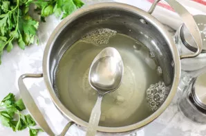 Pour boiling water and add vinegar. Put the pot on the stove and bring its contents to a boil.