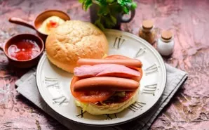Cut the sausages lengthwise and put on top of the tomato.