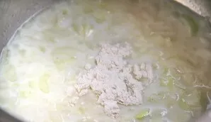 Pour in the milk, stir and add flour.