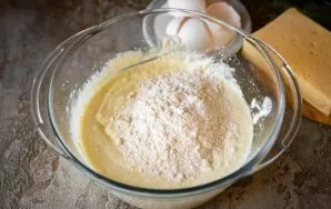 Add flour. Flour may be needed more or less, it depends on the humidity of the cottage cheese.