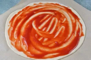 The resulting dough should be kneaded and divided into two parts, resulting in two pizzas with a diameter of 30 centimeters. Roll out thi...