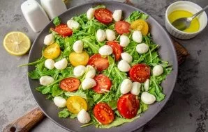 Lay out mini mozzarella balls on top of the salad.