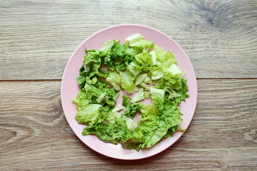 Tear the salad leaves with your hands and place them on a serving plate. Top with the ricotta and tomato salad and serve immediately.