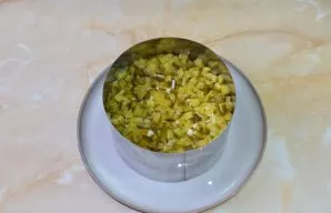 Finely chop the pickled cucumbers. If you grate them, they will release juice and spoil the appearance of the salad. Lay a layer of cucum...