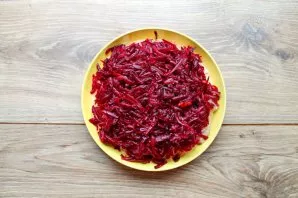 Grate the boiled beets on a medium or coarse grater and completely cover the salad with an even layer. Grease the beetroot layer with may...