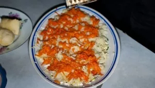 The next layer is boiled carrots, also grated.