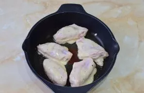Pour oil into a hot frying pan and roll the wings in the dough. Cook them on low heat for 3-4 minutes on each side.