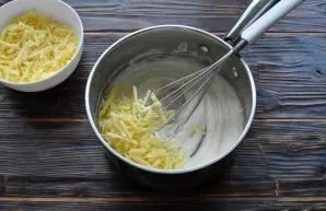 Remove the hot sauce from the heat, add salt, ground white pepper and a handful of grated cheese. Mix the prepared Mornay sauce with a wh...