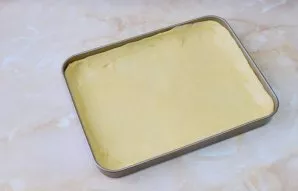 Divide the dough into two unequal parts. Put the smaller part in the freezer to stiffen. Put most of it in a baking dish and spread over ...