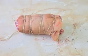 Tightly twisted into a roll and tied with a thread.