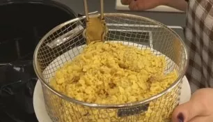 Dip each piece of meat in proteins, then in flour, again in proteins and in corn crumbs. Lay out the pieces on a plate or baking grill.