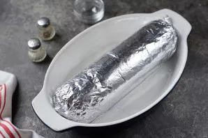 Roll everything into a roll in the form of sausage, put in a baking dish, pour a little water. Place in an oven preheated at 190 degrees ...