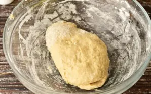 Knead the dough with your hands. Leave for 20-30 minutes. During this time, gluten will form and it will be easier to roll out the dough.