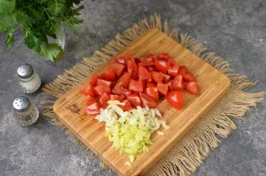After a while, pierce a couple of slices of potatoes with a knife, it must be half-boiled and only then add chopped tomatoes and celery t...