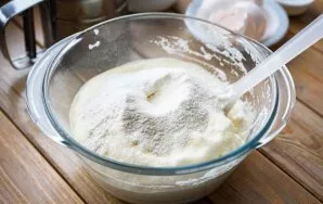 Sift the flour in parts, stirring the flour with a spatula with gentle movements.