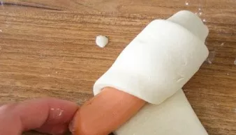 Wrap a sausage in each strip, wrap it in a spiral.