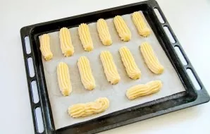 Transfer the dough to a bag with a nozzle and place it on a baking sheet with baking paper.