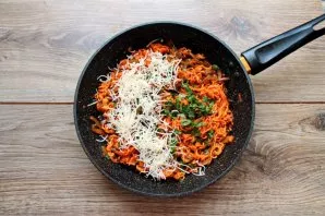 Add chopped greens and grated cheese to the pan. Mix everything, remove from heat and serve.