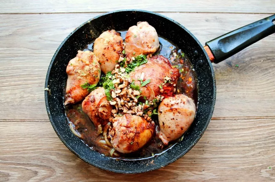 Pour red wine into the pan, close the lid, reduce the heat to minimum and simmer everything for 60-90 minutes. Turn the chicken 2-3 times...