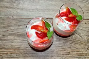 Garnish the top of the yogurt with the remaining strawberries and mint.