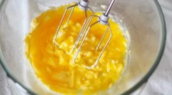 Cool the prepared yolk mass to room temperature and, beating, pour into soft butter.