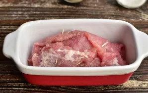 Transfer the roll to the baking dish.