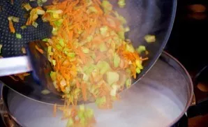 Pour the fried vegetables into the broth. Season with salt and pepper to taste.