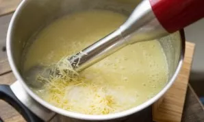Cook until potatoes and cabbage are cooked. Then remove the pot from the stove and pour in the milk. Also add grated cheese. Using a blen...