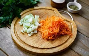 During this time, finely chop the onion, and grate the carrots on a coarse grater.