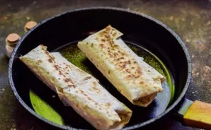 Roll up the lavash and toast in a dry frying pan for 1.5-2 minutes on each side.