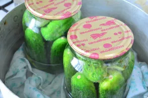 Put the cucumber jars in a saucepan with warm water and sterilize the cucumbers for 5 minutes. Put a cloth under the jars so that the gla...