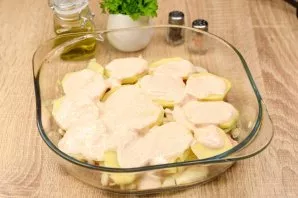 Spread half of the Greek yogurt on top of the potato layer.