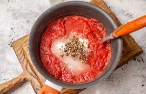 Add salt, sugar, oil and spices to tomato puree.