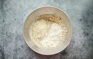 Add both flour and a pinch of salt, stir with a spatula.