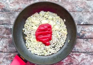 Add tomato paste to the pan with the onion and simmer for 1-2 minutes.