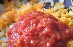 Then add chopped tomatoes to the vegetables. Stir and simmer for another 3 minutes.