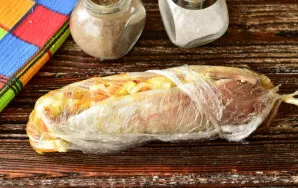 Roll the fish into a roll and wrap it in cling film.