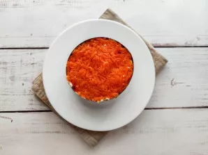 Put grated carrots on top of the potatoes.