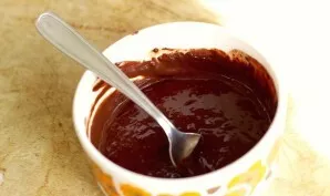 To prepare the icing, pour hot water over the cocoa and stir.