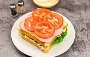 Put chopped tomatoes on top of the ham.