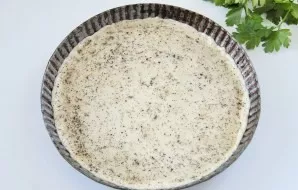 Grease the form with butter. On a lightly floured surface, thinly roll out the dough to the desired size and carefully transfer it to the...