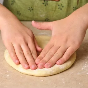 Make round balls and crush them into tortillas with your hands.